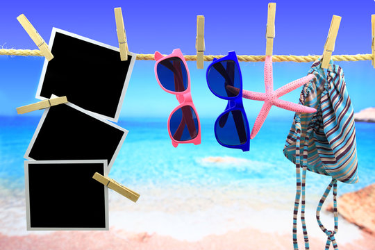 Photo frames and beach items hanging on a rope 