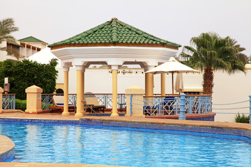 landscape with resort swimming pool, summer pavilion and deck c