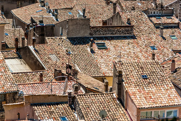 Roof tops with TV antennas and roofing tiles.