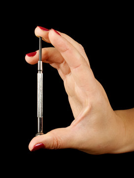 Woman hand holding sharp philips screwdriver