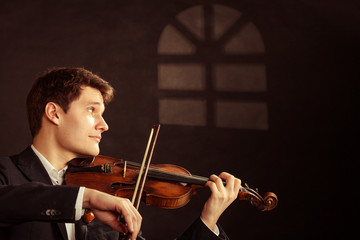 Man violinist playing violin. Classical music art