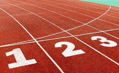 red plastic runway and numbers in a sports ground