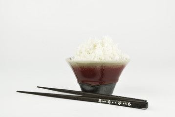 Rice in bowl and chopstick on white background
