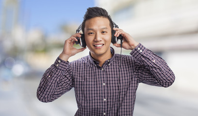 Handsome young asian man listening to music