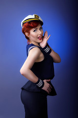 Pin up model in sailor costume isolated on blue background