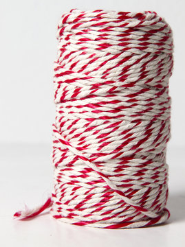 Roll of red and white rope for parcel