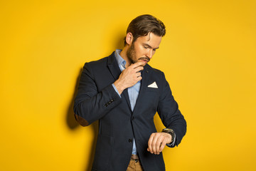 Young handsome man checking the time