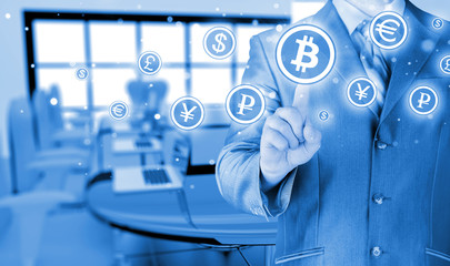 Choosing bitcoins, businessman pressing touch screen button.