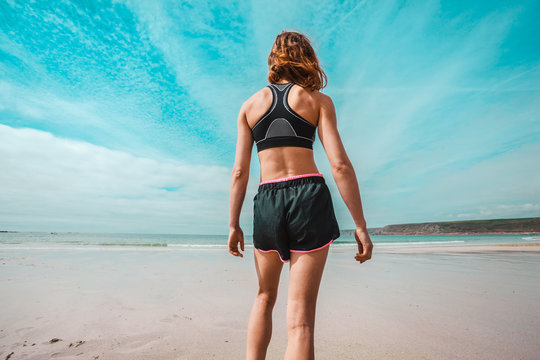 Athletic young woman standing on the beach