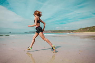Young woman running on the beach