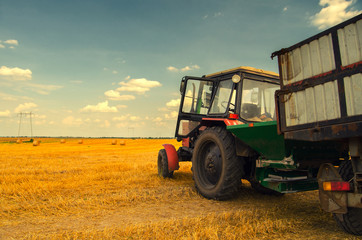 Modern red tractor on the agricultural field