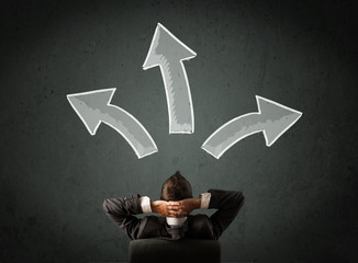 Businessman deciding with arrows above his head
