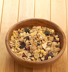 Plate with raw oatmeal on wooden table.