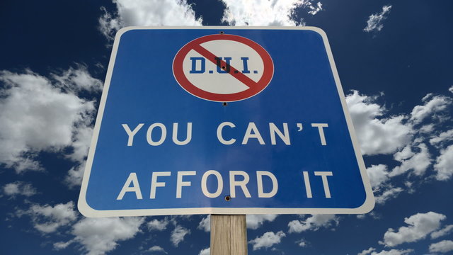 DUI You Can't Afford It Warning Sign with Time Lapse Clouds