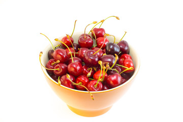 An orange bowl of cherries