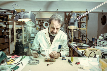 electronic engineer in the laboratory with a soldering iron