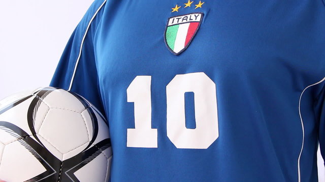 Footballer wearing Italian national outfit and holding a ball