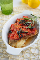 Baked cod under tomato sauce