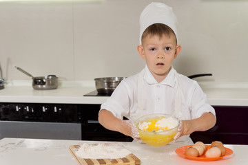 Adorable little boy pastry chef