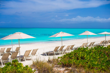 Beach chairs on exotic tropical white sandy beach