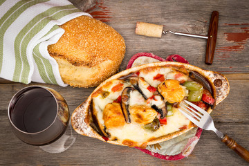 Chicken and vegetable stew with bread and wine