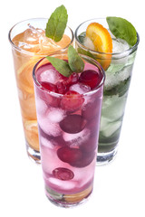 iced drinks with cherry, orange and mint on white background