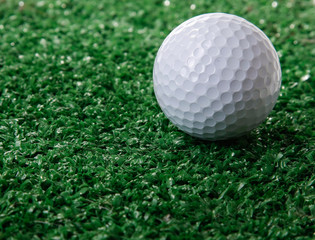 Golf ball ower green grass