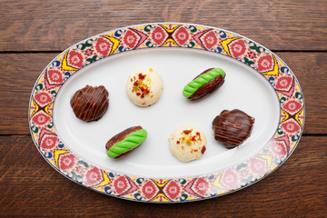 Chocolate candies in oriental style plate