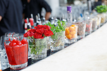 Cherries, herbs and flowers on bar counter