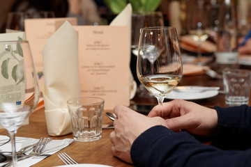 Glass of white wine in man's hands