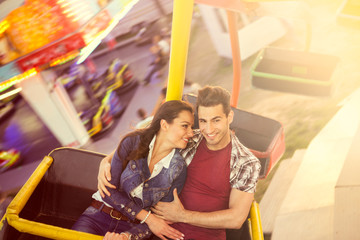 Young couple having a ride on a ferris wheel © luckybusiness