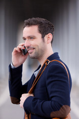 Young attractive man using smartphone in Paris