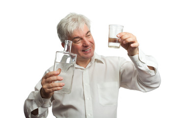 A man with a bottle of vodka and a glass.