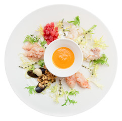 Raw seafood in plate isolated on white