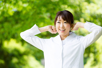 young asian doctor relaxing on green background