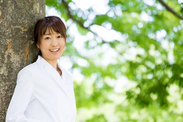 young asian doctor relaxing on green background