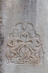 Fototapeta na wymiar Two Apsaras on the wall of Angkor Wat