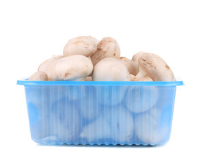 Champignon mushrooms on plastic box.