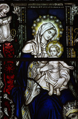 Mary holding her son Jesus in stained glass
