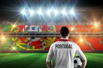 Composite image of portugal football player holding ball