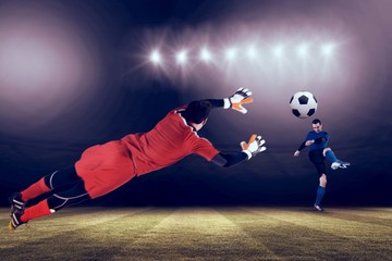 Composite image of fit goal keeper jumping up