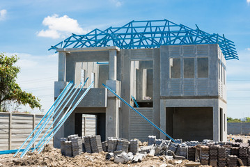 New home under construction using steel frames against cloudy sk
