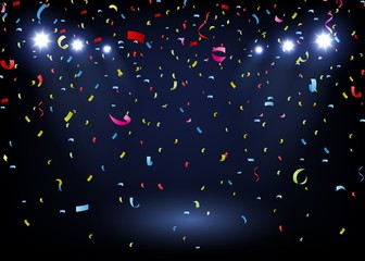 colorful confetti on black background with spotlight