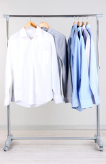 Office male clothes on hangers, on gray background