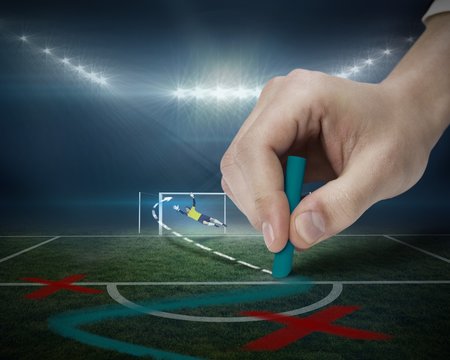 Hand drawing tactics on football pitch