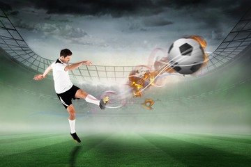 Naklejka premium Composite image of football player in white kicking