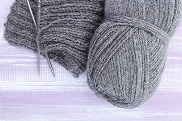 Knitting with spokes on wooden background