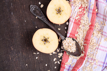 Apple with oatmeal and vintage spoons