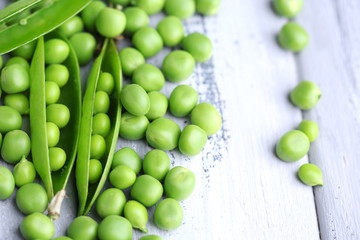 Fresh green peas on wooden background