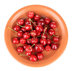 Sweet cherry on color plate isolated on white